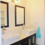 Guest Bedroom 1 ensuite bathroom with double sink vanity.